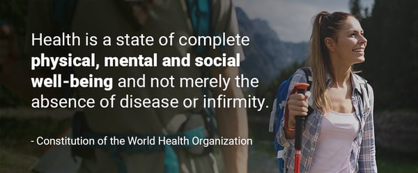 Image of the quote "Health is a state of complete physical, mental and social well-being and not merely the absence of disease or infirmity. - Constitution of the World Health Organization" over a woman hiking and smiling.