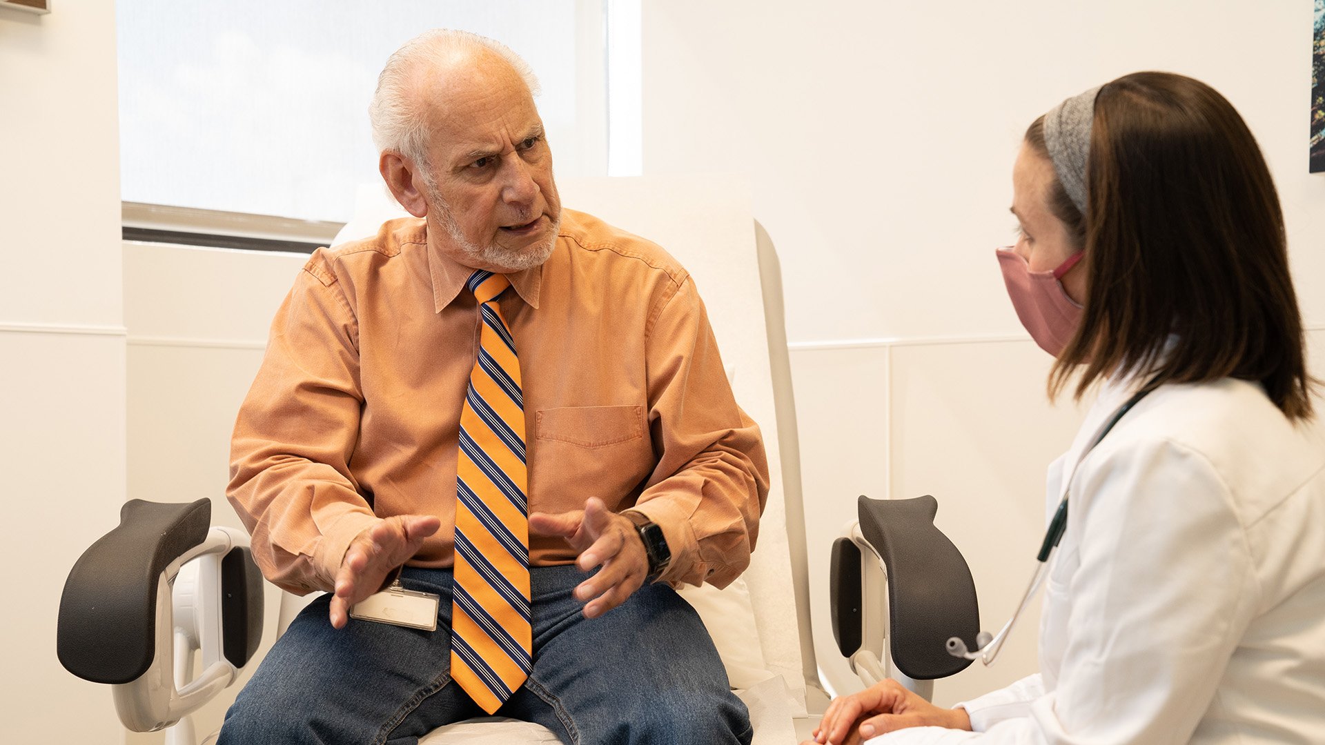 older-elderly-patient-talking-to-provider-mask